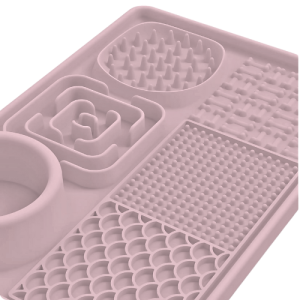 4-in-1 Multifunctional Dog Lick Mat - Reduce Boredom with Slow Feeder & Licking Zones Close-up of pink silicone 4-in-1 dog lick mat with varied textured zones and a built-in bowl, designed for mental stimulation.